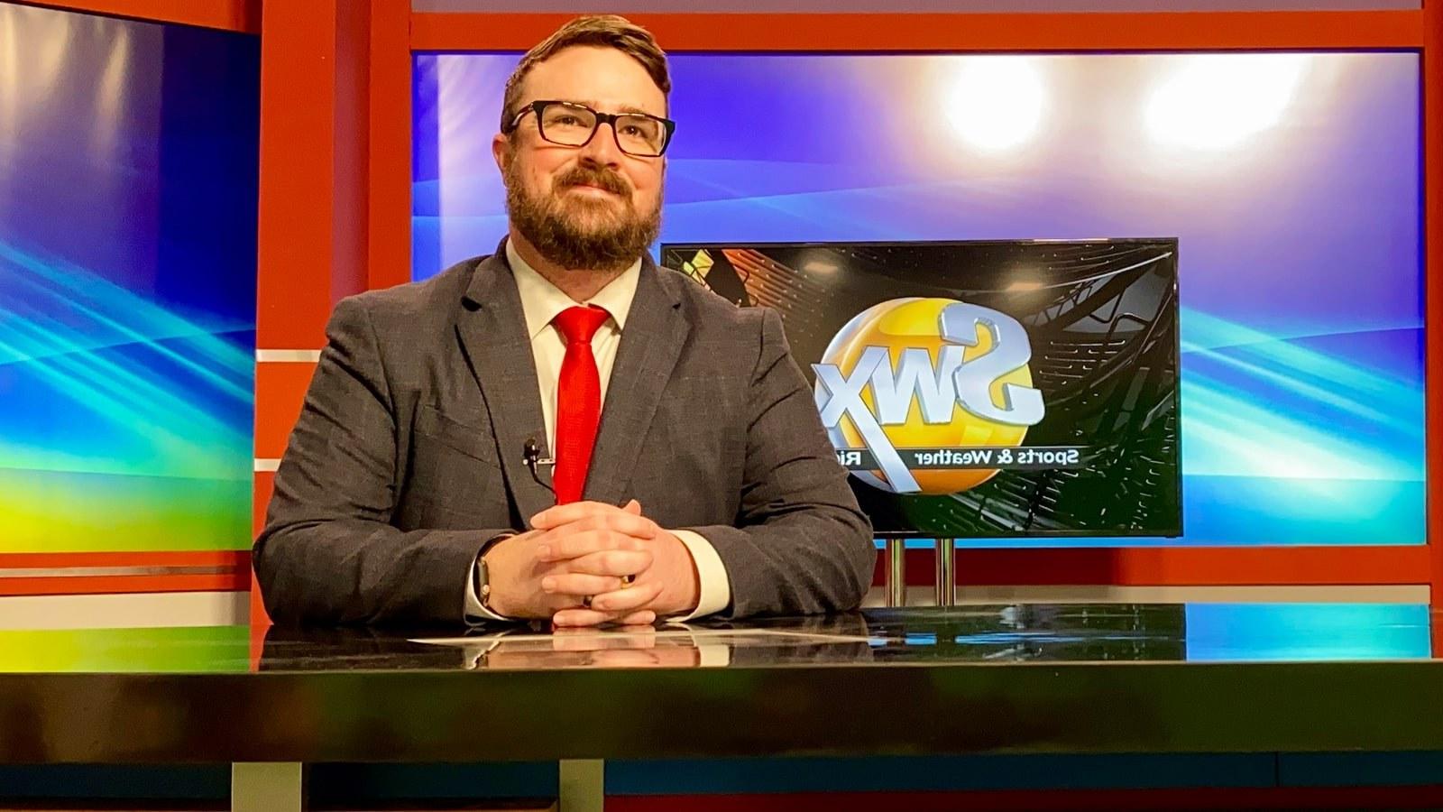 Richard Tieman wears a suit and sits at a TV broadcast desk. A screen behind him says SWX Sports and Weather.