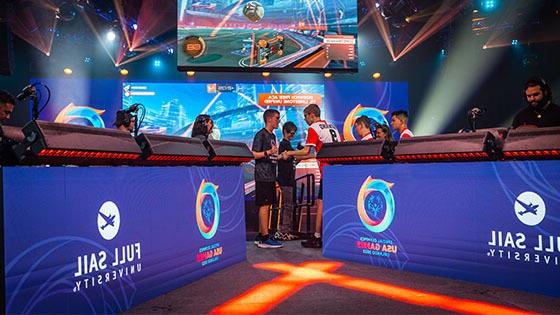 Two Special Olympians shaking hands after a match on stage at the 满帆大学 Orlando Health Fortress.