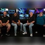 Four people sitting in front of a Grand MA lighting console at Full Sail University.